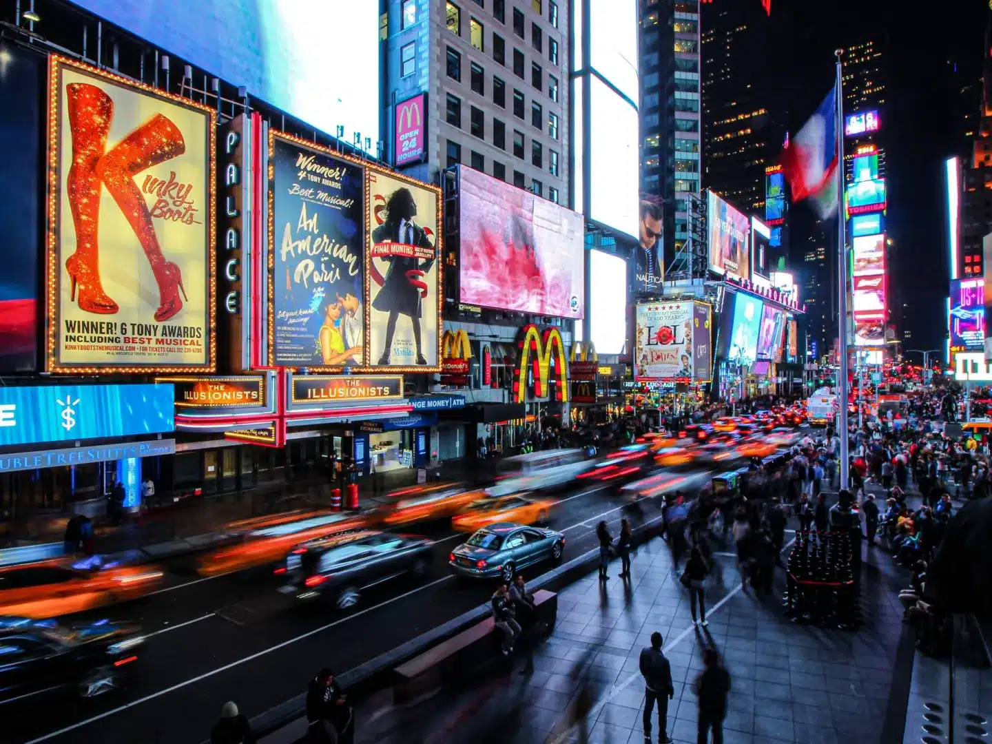 A photo of a busy street at night.